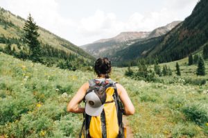 women in mountains wearing backpack